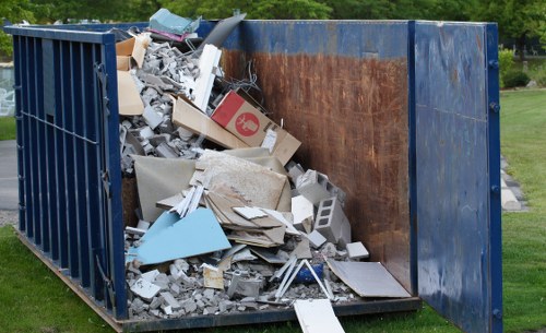Front view of a commercial waste collection truck at a business site